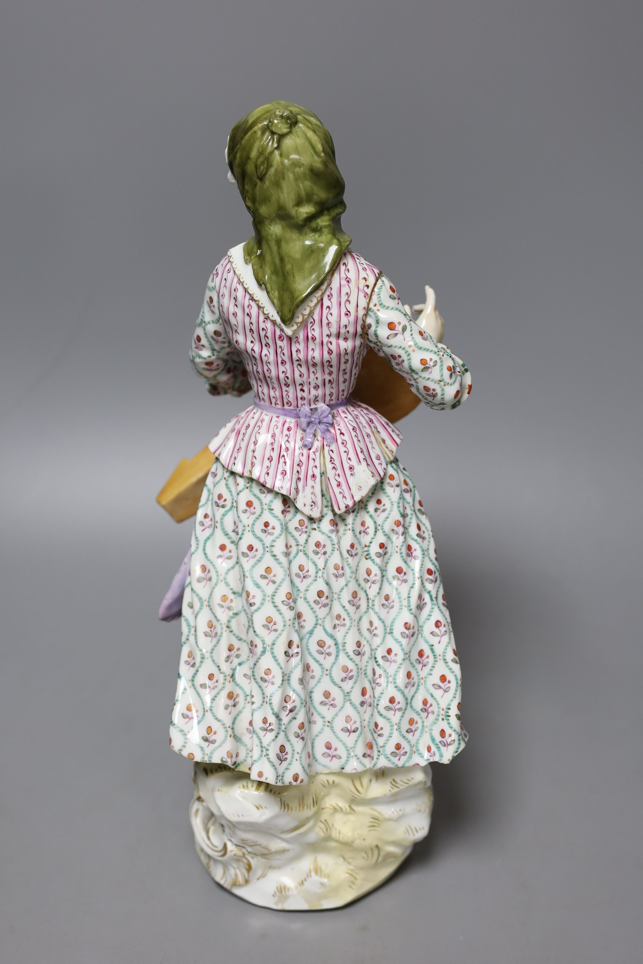 A large Meissen figure of a female hurdy gurdy player, 19th century - 33cm tall